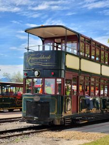 Charming two-storey tram at the popular Franschhoek wine tram station, perfect for travel and tourism.